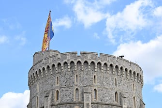 WINDSOR, ENGLAND - SEPTEMBER 19: The Royal Standard flown on the Round Tower at Windsor Castle on September 19, 2022 in Windsor, England. The committal service at St George's Chapel, Windsor Castle, took place following the state funeral at Westminster Abbey. A private burial in The King George VI Memorial Chapel followed. Queen Elizabeth II died at Balmoral Castle in Scotland on September 8, 2022, and is succeeded by her eldest son, King Charles III. (Photo by Leon Neal/Getty Images)