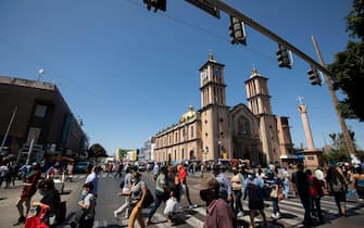 Tijuana, Baja California, Mexico - September 11, 2021: Crowds of people cross a street in downtown Tijuana.