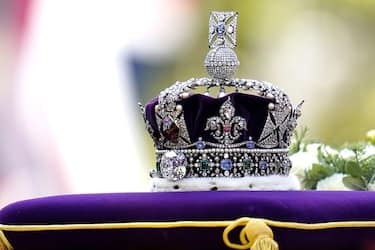 The coffin of Queen Elizabeth II, draped in the Royal Standard with the Imperial State Crown placed on top, is carried on a horse-drawn gun carriage of the King's Troop Royal Horse Artillery, during the ceremonial procession from Buckingham Palace to Westminster Hall, London, where it will lie in state ahead of her funeral on Monday. Picture date: Wednesday September 14, 2022. (Photo by Andrew Matthews/PA Images via Getty Images)