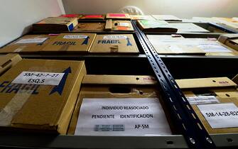 Boxes containing unidentified human remains are seen at the Argentine Forensic Anthropology Team (EAAF) offices in Buenos Aires on November 21, 2013. For nearly 30 years, the group has examined the remains of countless dead from all over the world, including those of revolutionary icon Che Guevara, who was executed in Bolivia more than 40 years ago. But its dozens of scientists are at work now on a task closer to home -- identifying the remains of hundreds of victims from Argentina's "Dirty War". The bones, retrieved from mass graves, are among the 30,000 Argentines who "disappeared" during the 1976-1983 dictatorship, and presumably were murdered by the regime. AFP PHOTO / DANIEL GARCIA        (Photo credit should read DANIEL GARCIA/AFP via Getty Images)