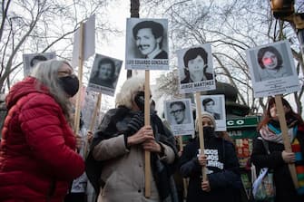 TOPSHOT - Demonstrators holding portraits of people who disappeared during the military dictatorship (1973-1985), take part in a protest called by the Madres y Familiares de Desaparecidos (Mothers and Relatives of Disappeared Detainees) organization, in Montevideo on September 4, 2020. - A retired army colonel arrested over crimes during the Uruguayan dictatorship admitted to murder, kidnapping and torture, according to official documents released on September 1. (Photo by Pablo PORCIUNCULA / AFP) (Photo by PABLO PORCIUNCULA/AFP via Getty Images)
