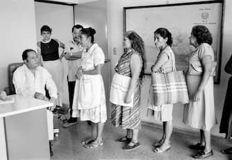SAN SALVADOR, EL SALVADOR - JANUARY 1: At the central office of the Salvadoran Human Rights Commission, a staff member, left, listens to women relay their cases regarding disappeared family members in San Salvador, El Salvador, January 1, 1983. It is estimated that between 8,000 and 10,000 people were forcibly disappeared from the years 1980 to 1992 in El Salvador. While the amnesty law passed after the signing of the peace accords guaranteed impunity for all individuals accused of grave crimes against humanity, including cases of disappeared people, efforts to locate and identify the missing continue as a significant element in the post-conflict process of national reconciliation. (Photo by Robert Nickelsberg/Getty Images)