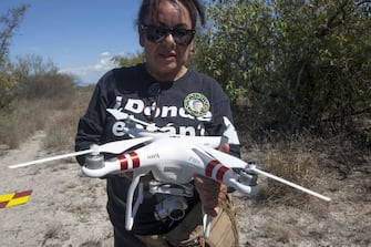 Leticia Hidalgo, member of Fuerzas Unidas por Nuestros Desaparecidos en Nuevo Leon (FUNDENL), prepares a drone -to search for missing person remains through ortho photogrametty- to fly over the "Las Abejas" coperative land, in the municipality of Salinas Victoria, Nuevo Leon state, on February 24, 2020. (Photo by Julio Cesar AGUILAR / AFP) (Photo by JULIO CESAR AGUILAR/AFP via Getty Images)