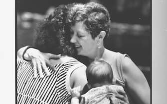 Feminist Norma McCorvey aka Jane Roe, the woman behind Roe V. Wade case, hugging her 23 yr.  old daughter, Cheryl while holding her baby granddaughter outside at hotel.  (Photo by Mark Perlstein / The LIFE Images Collection via Getty Images / Getty Images)