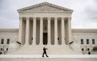 WASHINGTON, DC - SEPTEMBER 01: A Supreme Court Police officer patrols at the U.S. Supreme Court on September 1, 2021 in Washington, DC. A new Texas law that prohibits most abortions after six weeks of pregnancy went into effect on Wednesday. The U.S. Supreme Court did not act on a request to block the law. (Photo by Drew Angerer/Getty Images)