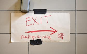 A hand drawn exit sign with “thank you for voting” is taped to the wall inside Robert Wagner Middle School as people participate in early voting in the 2020 Presidential Elections, in New York, NY, October 30, 2020. The school and other Upper East Side voting sites have been overloaded by long lines and fewer than necessary ballot scanners.  (Anthony Behar/Sipa USA)