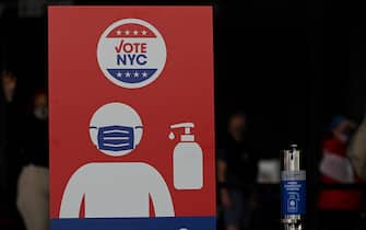 A large sign reminding people to wear masks and use hand sanitizers on display inside Barclays Center on the first day of early voting for the 2020 Presidential elections, in the  New York City borough of Brooklyn, NY, October 24, 2020. In a deal reached with the NBA, sports arenas such as the Barclays Center will be used as polling sites, one of 88 early voting ballot casting sites, this the first time in history New York participates in early voting.  (Anthony Behar/Sipa USA)