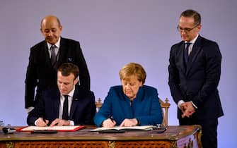 AACHEN, GERMANY - JANUARY 22: German Chancellor Angela Merkel and French President Emmanuel Macron sign the Aachen Treaty on January 22, 2019 in Aachen, Germany. The treaty is meant to deepen cooperation between the countries as a means to also strengthen the European Union. It comes 56 years to the day after then German Chancellor Konrad Adenauer and French President Charles de Gaulle signed the Elysee Treaty, or Joint Declaration of Franco-German Friendship. (Photo by Sascha Schuermann/Getty Images)