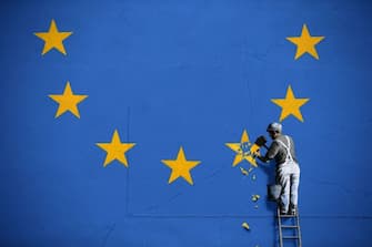 A recently painted mural by British graffiti artist Banksy, depicting a workman chipping away at one of the stars on a European Union (EU) themed flag, is pictured in Dover, south east England on May 8, 2017. (Photo by Daniel LEAL-OLIVAS / AFP) / RESTRICTED TO EDITORIAL USE - MANDATORY MENTION OF THE ARTIST UPON PUBLICATION - TO ILLUSTRATE THE EVENT AS SPECIFIED IN THE CAPTION (Photo by DANIEL LEAL-OLIVAS/AFP via Getty Images)