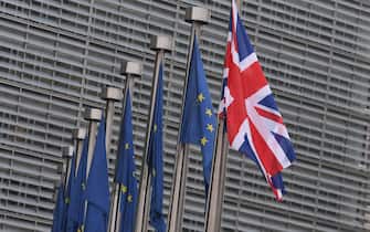 TOPSHOT - This photo taken on December 4, 2017 shows the British flag displayed next to flags of the European Union in front of the European Union Commission in Brussels. 
British Prime Minister Theresa May is set to meet key European Union figures for talks on Brexit which could determine whether the UK is able to move on to negotiations on trade. / AFP PHOTO / EMMANUEL DUNAND        (Photo credit should read EMMANUEL DUNAND/AFP via Getty Images)