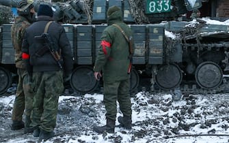 DONETSK REGION, UKRAINE - MARCH 11, 2022: Officers of the DPR People's Militia are seen by a T-64 tank of the Armed Forces of Ukraine in the city of Volnovakha that came under control of the Donetsk People's Republic (DPR). Tensions started heating up in Donbass on February 17, with the Donetsk and Lugansk People's Republics reporting the most intense shellfire from Ukraine in months. Early on February 24, Russian President Putin announced the start of a special military operation by the Russian Armed Forces in response to appeals for help from the leaders of both republics. Mikhail Tereshchenko/TASS/Sipa USA