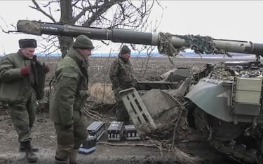 epa09829117 A handout still image taken from handout video made available by the Russian Defence ministry press-service shows militias of self-proclaimed DNR examine a tank that was abandoned by Ukrainian army during their retreat in Donetsk region, Ukraine, 16 March 2022. On 24 February Russian troops had entered Ukrainian territory in what the Russian president declared a 'special military operation', resulting in fighting and destruction in the country, a huge flow of refugees, and multiple sanctions against Russia.  EPA/RUSSIAN DEFENCE MINISTRY PRESS SERVICE / HANDOUT  HANDOUT EDITORIAL USE ONLY/NO SALES