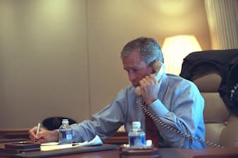 President George W. Bush confers with staff via telephone Tuesday, Sept. 11, 2001, from his office aboard Air Force One during the flight from Sarasota to Barksdale Air Force Base.  Photo by Eric Draper, Courtesy of the George W. Bush Presidential Library/Getty Images 