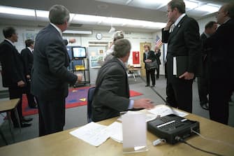 President George W. Bush watches television coverage of the attacks on the World Trade Center Tuesday, Sept. 11, 2001, during a briefing in a classroom at Emma E. Booker Elementary School in Sarasota, Fla.  Photo by Eric Draper, Courtesy of the George W. Bush Presidential Library/Getty Images 