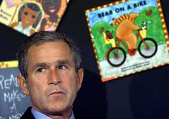 TOPSHOT - US President George W. Bush reacts after having his morning school reading event interupted by his Chief of Staff Andrew Card (not in photo) shortly after news of the New York City airplane crashes was available in Sarasota, Florida. The suspected terrorist attacks also hit Washington DC. The planes in New York caused the collapsed of the twin towers at the World Trade Center. The plane that crashed in Washington hit the Pentagon.    AFP Photo Paul J. RICHARDS (Photo by Paul J. RICHARDS / AFP) (Photo by PAUL J. RICHARDS/AFP via Getty Images)
