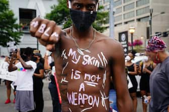 ATLANTA, GA - JUNE 06: A man with "My skin is not a weapon" writton on his torso poses for a photo during a protest against police brutality on June 6, 2020 in Atlanta, Georgia. This is the 12th day of protests since George Floyd died in Minneapolis police custody on May 25. (Photo by Elijah Nouvelage/Getty Images)