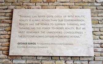 A quote of the founder of the English-language Central European University (CEU) Hungarian born American businessman George Soros is seen at the main entrance in Budapest on March 29, 2017. 
The English-language CEU set up in Budapest by Hungarian born American businessman Georg Soros in 1991 after the fall of communism, has long been seen as a hostile bastion of liberalism by Prime Minister Viktor Orban's right-wing government. / AFP PHOTO / ATTILA KISBENEDEK        (Photo credit should read ATTILA KISBENEDEK/AFP via Getty Images)