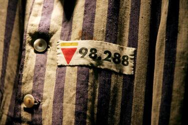 LONDON - DECEMBER 9: The prison uniform of Auschwitz survivor Mr Leon Greenman, priosoner number 98288 is displayed on December 9, 2004 at the Jewish Museum in London, England. Mr. Greenman O.B.E age 93 and a British citizen, spent three years of his life in six different concentration camps during World War II and since 1946 he has tirelessly recounted his life through his personal exhibition at the museum where he conducts educational events to all age groups. January 2005 will be the 60th anniversary of the liberation of the extermination and concentration camps, when survivors and victims who suffered as a result of the Holocaust will commemorated across the world. (Photo by Ian Waldie/Getty Images)