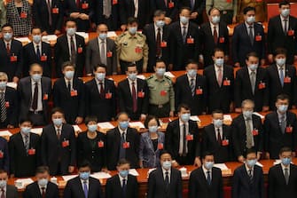BEIJING, CHINA - MAY 27: Attendees of the closing session of the Chinese People's Political Consultative Conference stand and sing the national anthem during the ceremony on May 27, 2020 at The Great Hall Of The People in Beijing, China. (Photo by Andrea Verdelli/Getty Images)