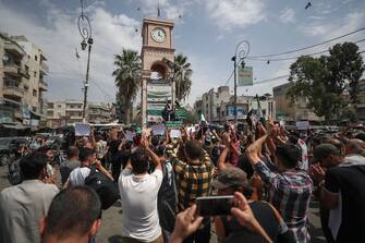 Syrians cheer a speaker during a demonstration against President Bashar al-Assad in Idlib city, in the eponymous northwestern province, on September 11, 2020. (Photo by OMAR HAJ KADOUR / AFP) (Photo by OMAR HAJ KADOUR/AFP via Getty Images)