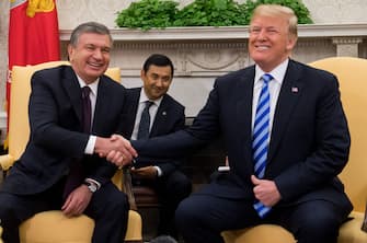 US President Donald Trump shakes hands with President Shavkat Mirziyoyev of Uzbekistan during a meeting in the Oval Office of the White House in Washington, DC, May 16, 2018. (Photo by SAUL LOEB / AFP)        (Photo credit should read SAUL LOEB/AFP via Getty Images)