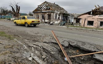 epaselect epa09893776 A car drives through a damaged street in Kukhari, Kyiv Oblast, Ukraine, 16 April 2022. On 24 February Russian troops entered Ukrainian territory resulting in fighting and destruction in the country, a huge flow of refugees, and multiple sanctions against Russia.  EPA/OLEG PETRASYUK