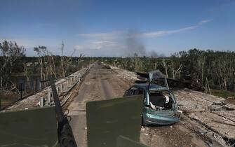 epa09992806 Ukrainian servicemen drive an APC on a damaged road near the front line in the city of Severodonetsk, Luhansk region, Ukraine, 02 June 2022, where heavy fighting took place in the last few days. While addressing the Luxembourg parliament, Ukrainian President Volodymyr Zelensky said that as of 02 June, about 20 percent of Ukraine is under the control of Russia. Russian troops on 24 February entered Ukrainian territory, starting a conflict that has provoked destruction and a humanitarian crisis.  EPA/STR
