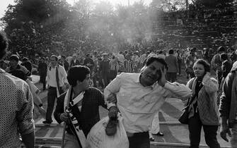 468991486 Supporters flee 29 May 1985 the scene of riots in Heysel football stadium in Brussels after thirty-nine Juventus football fans died during rioting at the European Cup Final in Brussels. Shortly before kick off the atmosphere turned violent and Liverpool supporters stampeded through a thin line of police towards the rival fans. As the Juventus fans retreated a wall collapsed under the pressure and fans were crushed and trampled to death in the panic. AFP PHOTO DOMINIQUE FAGET / AFP PHOTO / DOMINIQUE FAGET (Photo credit should read DOMINIQUE FAGET/AFP via Getty Images)