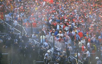 1291415 1985: The barriers collapse as supporters try to get on to the pitch during the European Cup Final between Liverpool and Juventus at the Heysel Stadium in Brussels, Belgium. Juventus won the match 1-0. \ Mandatory Credit: David Cannon/Allsport