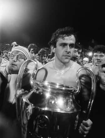 459824680 A thoughtful Michel Platini holds the cup, on May 29, 1985 after the Juventus victory on Liverpool, at European Champion Clubs final, at the Heysel stadium. Violence broke out between Britain's Liverpool hooligans and Italy's Juventus of Turin supporters one hour before the beginning of the match, killing 39 fans and injuring more 600 others. The tragedy occured when a wall collapsed in the stadium under the pressure of people and crushed Juventus fans as they tried to escape Liverpool supporters. (Photo credit should read DOMINIQUE FAGET/AFP via Getty Images)