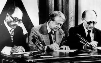 Sep 17, 1978 - Thurmont, Maryland, USA - Egyptian President ANWAR SADAT, left, JIMMY CARTER, center, and Israeli Prime Minister MENACHEM BEGIN signing peace treaty between Egypt and Israel known as the Camp David Accords because of the location where the peace deal was created.  (Credit Image: © Keystone Press Agency/Keystone USA via ZUMAPRESS.com)