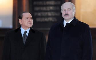 Italian Prime Minister Silvio Berlusconi (L) and Belarus President Alexander Lukashenko (R) listen to the states anthems during their meeting with in Minsk on November 30, 2009. Italian Prime Minister Silvio Berlusconi arrived in Belarus, making the first visit by a Western leader in 15 years to the country. AFP PHOTO / VIKTOR DRACHEV (Photo credit should read VIKTOR DRACHEV/AFP via Getty Images)