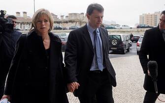 The parents of missing British girl Madeleine McCann Gerry (C) and Kate McCann (L) arrive at Tribunal Civil de Lisboa in Lisbon on February 10, 2010, after the lunch break for the last court session of their libel action against Goncalo Amaral the Portuguese police officer who led the initial probe in the case.  Kate and Gerry McCann are suing Amaral for 1.2 million euros (1.7 million dollars) for defamation over allegations he made in a book that their daughter was dead and that they were involved in her disappearance.  Madeleine went missing from a holiday apartment in the Algarve resort of Praia da Luz on May 3, 2007, a few days before her fourth birthday, as her parents and their friends dined at a nearby restaurant. AFP PHOTO/ FRANCISCO LEONG (Photo credit should read FRANCISCO LEONG/AFP via Getty Images)