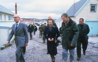 British Prime Minister Margaret Thatcher and her husband Denis (1915 - 2003, left) visit Stanley Junior School, Stanley in the Falkland Islands, 1983. (Photo by Keystone/Hulton Archive/Getty Images)