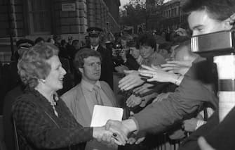 (Original Caption) 6/10/1983-London, England- Jubilant crowds, at the barrier across Downing Street, are shown offering a cluster of hands for Britain's re-elected Prime Minister, Margaret thatcher, to shake hands as she returns to No.10 with a landslide general election.