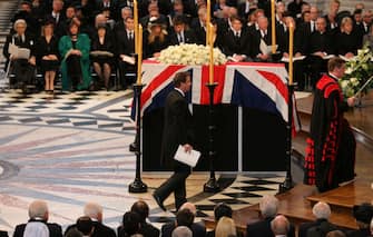 LONDON, ENGLAND - APRIL 17:  British Prime Minister David Cameron walks past the coffin prior to his reading during the Ceremonial funeral of former British Prime Minister Baroness Thatcher at St Paul's Cathedral on April 17, 2013 in London, England. Dignitaries from around the world today join Queen Elizabeth II and Prince Philip, Duke of Edinburgh as the United Kingdom pays tribute to former Prime Minister Baroness Thatcher during a Ceremonial funeral with military honours at St Paul's Cathedral. Lady Thatcher, who died last week, was the first British female Prime Minister and served from 1979 to 1990  (Photo by Christopher Furlong - WPA Pool/Getty Images)