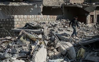 ALEPPO, SYRIA - MARCH 29: A Syrian man tries to find usable staffs from the debris of collapsed buildings after cleansing of the Al-Bab district of Aleppo from Daesh during the "Operation Euphrates Shield" in Aleppo, Syria on March 29, 2017. The Turkish-led Operation Euphrates Shield began in late August to improve security, support coalition forces, and eliminate the terror threat along the Turkish border using FSA fighters backed by Turkish artillery and jets. 
 (Photo by Kerem Kocalar/Anadolu Agency/Getty Images)