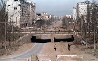 MOS03-20000328-GROZNY, CHECHNYA, RUSSIAN FEDERATION: Chechen people walk along a destroyed street of Chechen capital Grozny on Monday, 27 March 2000. Russian Interior Minister Vladimir Rushailo flew to Chechnya on Wednesday, 29 March 2000, as hundreds of rebels continued to resist federal forces in a village deep in the southern mountains.   EPA PHOTO  EPA/STRINGER