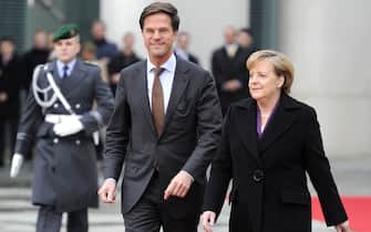 German Chancellor Angela Merkel (R) and Dutch prime minister Mark Rutte (L) inspects the guard of honour during a welcoming ceremony ahead of a meeting at the Chancellery in Berlin, on November 19, 2010.  AFP PHOTO/ODD ANDERSEN (Photo credit should read ODD ANDERSEN/AFP via Getty Images)
