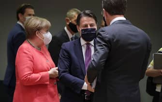 Germany's Chancellor Angela Merkel (L) , Italy's Prime Minister Giuseppe Conte (C) and Netherlands' Prime Minister Mark Rutte talks prior the start of the European Union Council in Brussels on July 17, 2020, as the leaders of the European Union hold their first face-to-face summit over a post-virus economic rescue plan. - The EU has been plunged into a historic economic crunch by the coronavirus crisis, and EU officials have drawn up plans for a huge stimulus package to lead their countries out of lockdown. (Photo by STEPHANIE LECOCQ / POOL / AFP) (Photo by STEPHANIE LECOCQ/POOL/AFP via Getty Images)