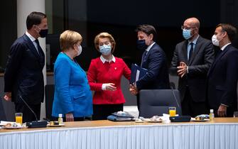 (LtoR) Dutch Prime Minister Mark Rutte, German Chancellor Angela Merkel, European Commission President Ursula von der Leyen, Italy's Prime Minister Giuseppe Conte, European Council President Charles Michel and French President Emmanuel Macron speak together ahead of an EU summit at the European Council building in Brussels, on July 18, 2020, as the leaders of the European Union hold their first face-to-face summit over a post-virus economic rescue plan. - The EU has been plunged into a historic economic crunch by the coronavirus crisis, and EU officials have drawn up plans for a huge stimulus package to lead their countries out of lockdown. (Photo by Francisco Seco / POOL / AFP) (Photo by FRANCISCO SECO/POOL/AFP via Getty Images)