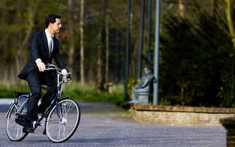 Dutch Prime Minister Mark Rutte arrives on his bicycle at the Catshuis in The Hague on April 13, 2012 before a meeting on the upcoming billions of cuts.  AFP PHOTO / ANP / ROBIN UTRECHT
netherlands out (Photo credit should read ROBIN UTRECHT/AFP via Getty Images)