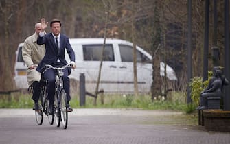 Dutch Prime Minister Mark Rutte (R) and Stef Blok from the People's Party for Freedom and Democracy (VVD) arrive on their bicycles at  Catshuis, the official residence of the Prime Minister, in the Hague, on March 29, 2012.  AFP PHOTO/ ANP EVERT-JAN DANIELS netherlands out  (Photo credit should read Evert-Jan Daniels/AFP via Getty Images)
