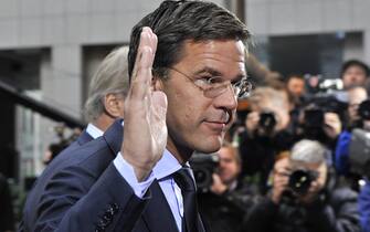 Dutch Prime Minister Mark Rutte waves as he arrives prior to an European Council at the Justus Lipsius building, EU headquarters in Brussels on October 23, 2011. Europe aimed to nail down a solution to the worst economic crisis in its history, as the spotlight at an emergency meeting of EU leaders fell on Italy amid contagion fears in the eurozone. The two key players, Germany Chancellor Angela Merkel and French President Nicolas Sarkozy, hailed "progress" in fighting the crisis as finance ministers thrashed out a framework to protect banks after a marathon session of talks.      AFP PHOTO/ GEORGES GOBET (Photo credit should read GEORGES GOBET/AFP via Getty Images)