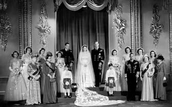 Princess Elizabeth and Lt Philip Mountbatten with close relatives and bridesmaids in the Throne Room at Buckingham Palace immediately ater the wedding ceremony. In the front row are (L-R) Queen Mary (the King's Mother) Princess Andrew of Greece (Duke of Edinburgh's mother) the late Prince William of Gloucester with the fellow pageboy Prince Micheal of Kent , King George VI and the Queen Mother. Back row; The bridesmaids are left to right: The Hon. Margaret Elphinstone, The Hon. Pamela Mountbatten, Lady Mary Cambridge, HRH Princess Alexandra of Kent, HRH The Princess Margaret, Lady Caroline Montagu-Douglas-Scott, Lady Elizabeth Lambart and The Hon. Diana Bowes-Lyon.   (Photo by PA Images via Getty Images)