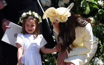 epa06750665 Britain's Catherine, Duchess of Cambridge (R) and her daughter Princess Charlotte (L) leave St George's Chapel in Windsor Castle after the royal wedding ceremony of Prince Harry, Duke of Sussex and Meghan, Duchess of Sussex in Windsor, Britain, 19 May 2018. The couple have been bestowed the royal titles of Duke and Duchess of Sussex on them by the British monarch.  EPA/NEIL HALL / POOL