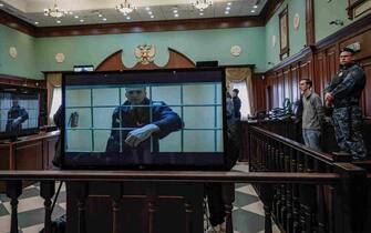 epa10364992 epa09971349 Russian opposition leader Alexei Navalny is shown on a monitor screen via video link from the penal colony No. 2 (IK-2) in Pokrov in Vladimir region, during a hearing of an appeal against Lefortovsky court sentence at the Moscow city court in Moscow, Russia, 24 May 2022. The Lefortovsky court sentenced politician Alexei Navalny to nine years in a strict regime colony and a fine of 1.2 million rubles for large-scale fraud and insulting the court. The Moscow city court upholded Navalny's conviction.  EPA/YURI KOCHETKOV  EPA-EFE/YURI KOCHETKOV