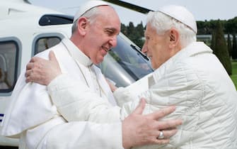 This handout picture released by the Vatican press office on March 23, 2013 shows "pope emeritus" Benedict XVI (R) greeting Pope Francis upon his arrival at the heliport in Castel Gandolfo. Pope Francis prepared to go face to face with his predecessor Benedict XVI on Saturday in a historic meeting between two men with very different styles but important core similarities.  AFP PHOTO / OSSERVATORE ROMANO/HO   RESTRICTED TO EDITORIAL USE - MANDATORY CREDIT "AFP PHOTO / OSSERVATORE ROMANO" - NO MARKETING NO ADVERTISING CAMPAIGNS - DISTRIBUTED AS A SERVICE TO CLIENTS (Photo by - / OSSERVATORE ROMANO / AFP) (Photo by -/OSSERVATORE ROMANO/AFP via Getty Images)