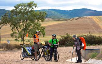 Pilgrims cycling with baby the Camino de Santiago Pilgrim's route to Santiago de Compostela in Galicia, Spain