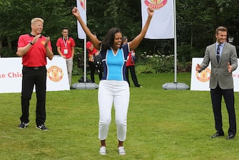 LONDON, ENGLAND - JULY 27:  First Lady of the United States, Michelle Obama (C) celebrates as Peter Schmeichel (L) and David Beckham (R) look on as Nickelodeon joins Let's Move for 'Let's Move London' event at the American Ambassadors Residence, Winfield House, Regents Park on July 27, 2012 in London, England.  (Photo by Tim Whitby/Getty Images For Nickelodeon)